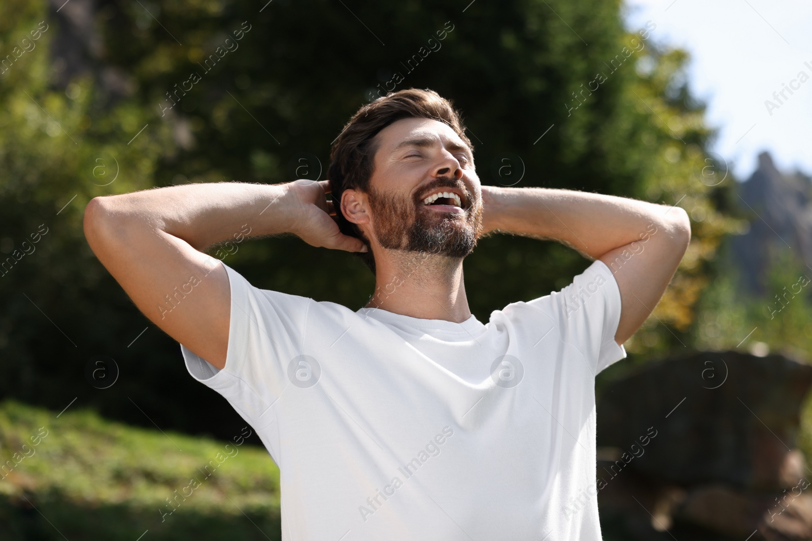 Photo of Feeling freedom. Man enjoying nature outdoors on sunny day