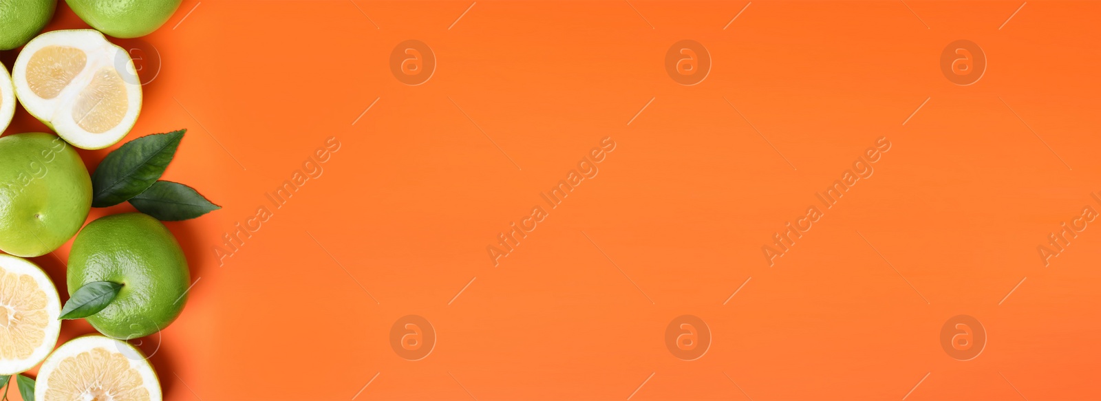 Image of Fresh ripe sweeties and green leaves on orange background, flat lay. Banner design