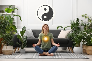 Image of Woman meditating at home. Yin and yang symbol over her