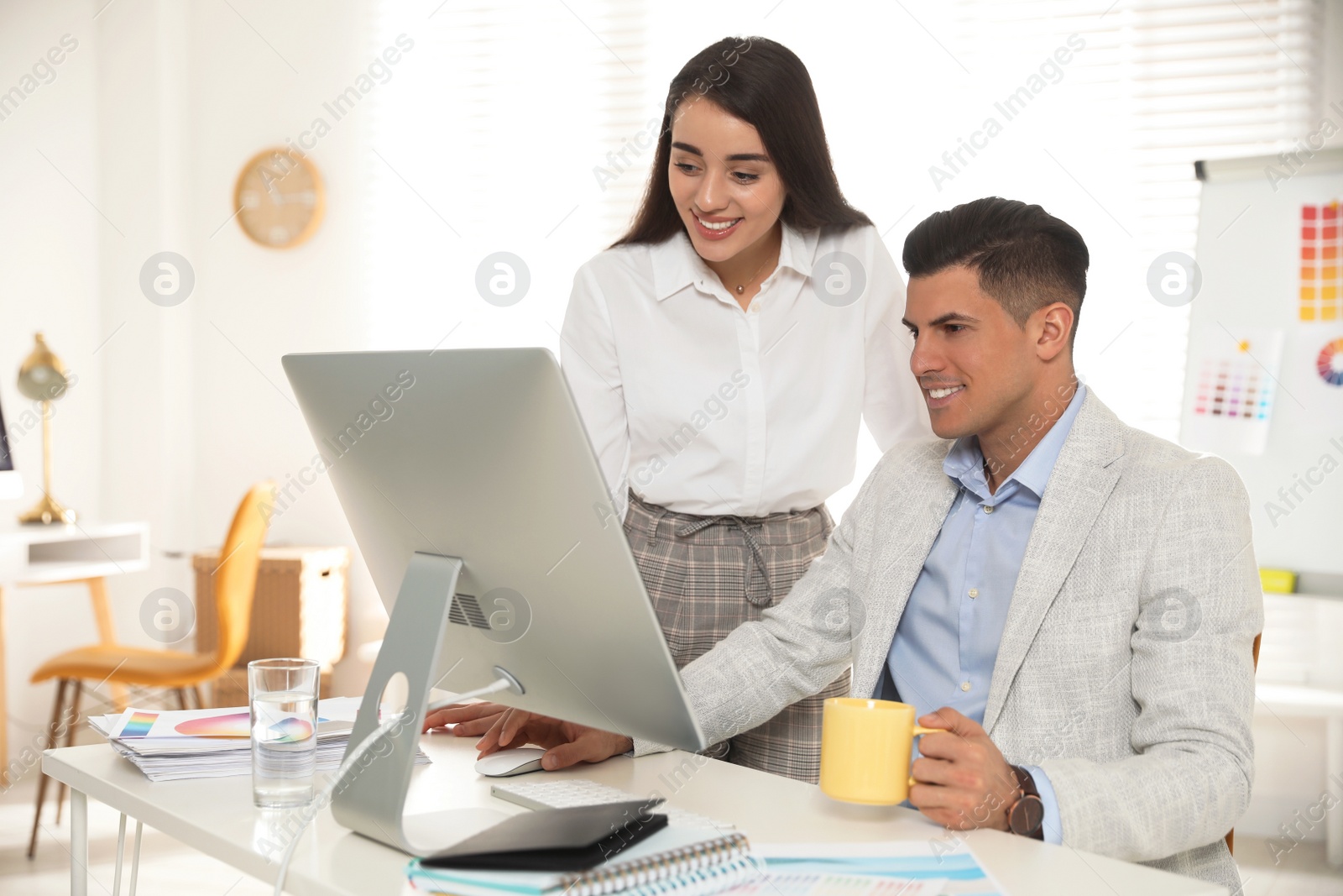 Photo of Professional designers working together in modern office