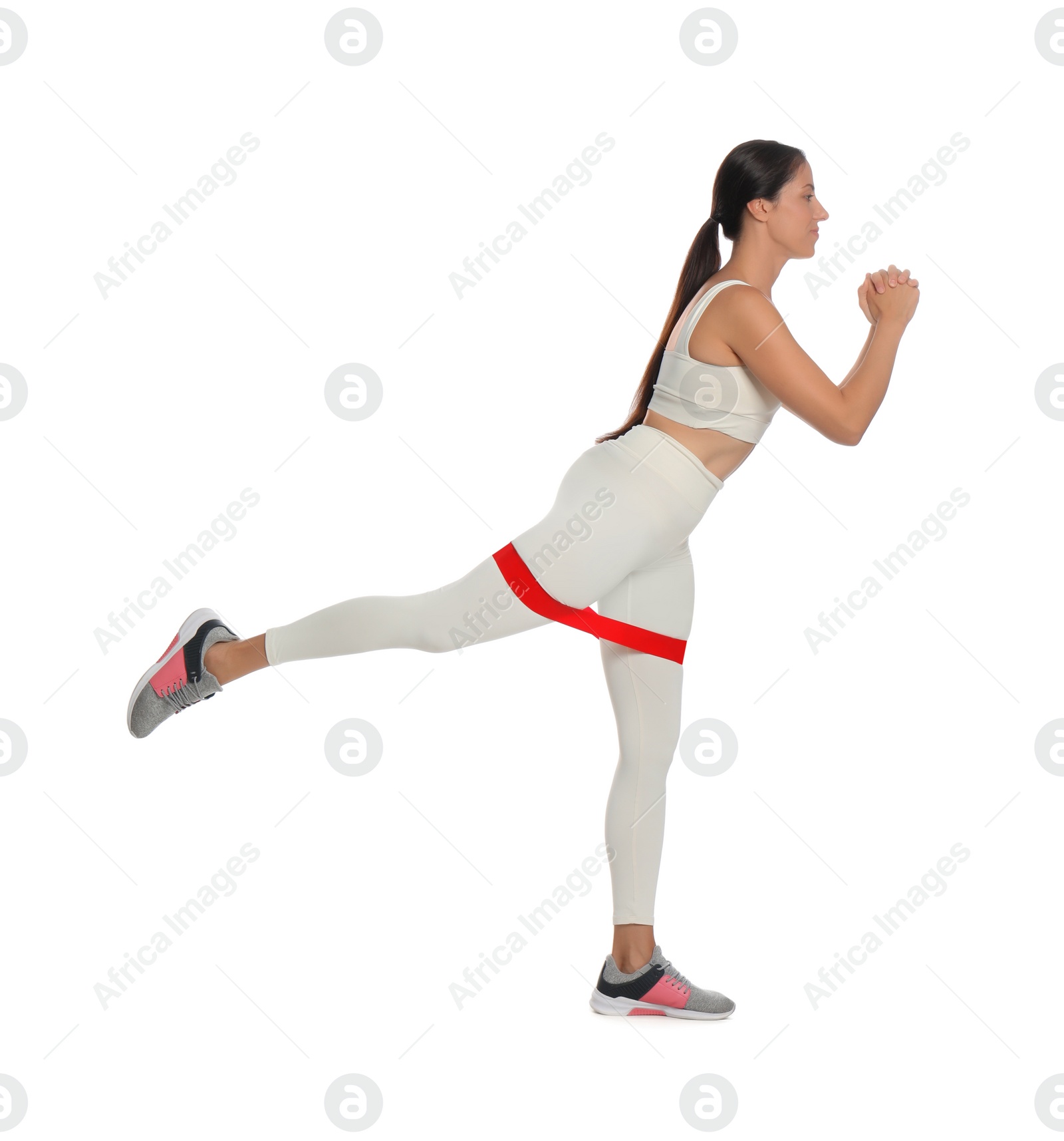 Photo of Woman doing sportive exercise with fitness elastic band on white background