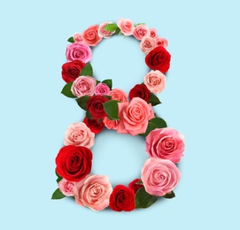 Image of International women's day. Number 8 made of beautiful flowers on pale blue background, top view