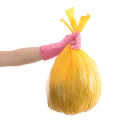 Photo of Woman holding plastic bag full of garbage on white background, closeup