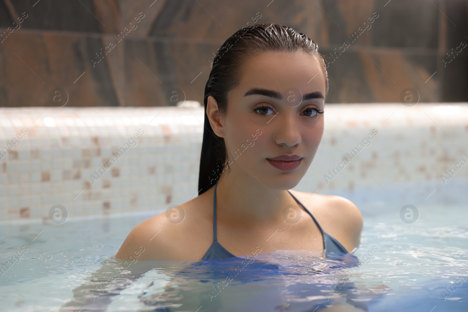 Photo of Beautiful woman relaxing in spa swimming pool