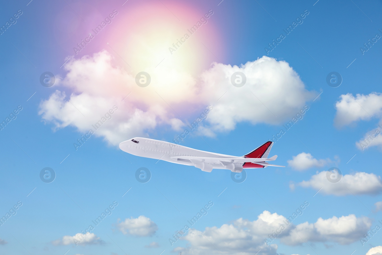 Image of Airplane flying in blue sky with clouds. Air transportation