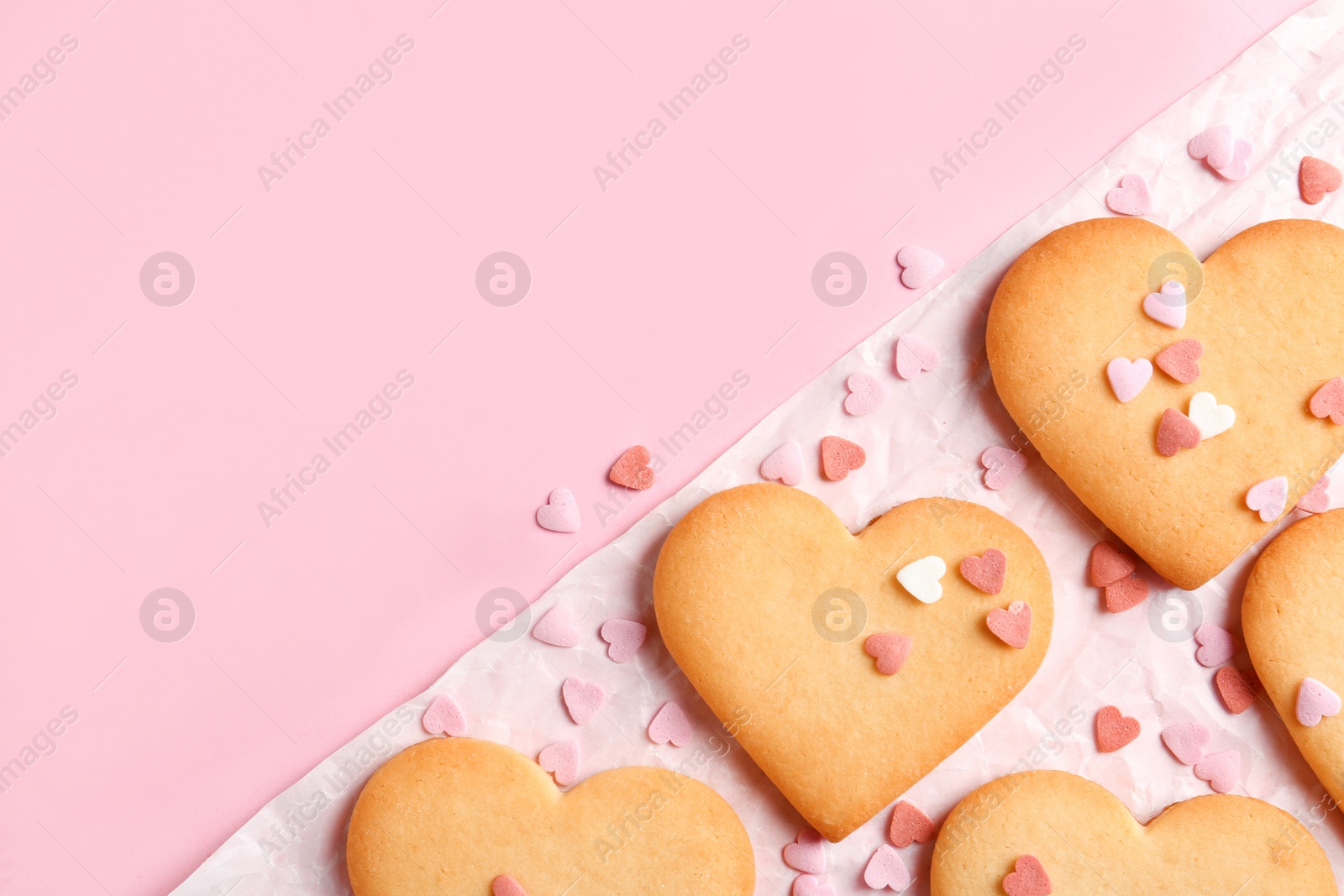 Photo of Composition with homemade heart shaped cookies and space for text on color background, top view