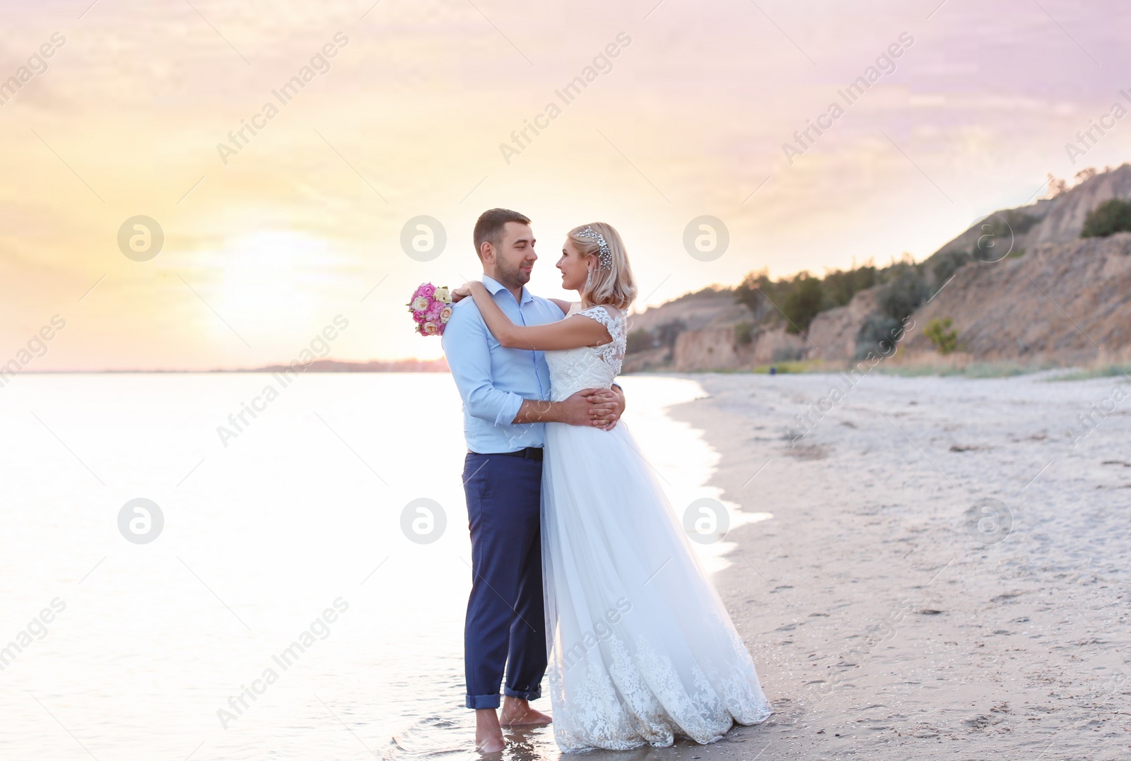 Photo of Wedding couple. Bride and groom standing on beach