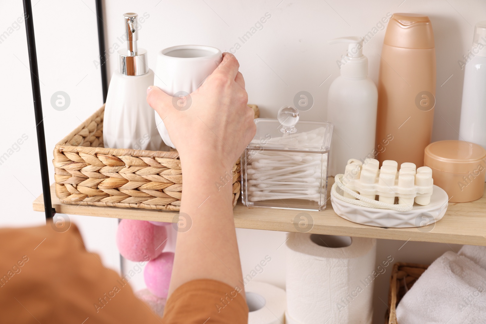 Photo of Bath accessories. Woman organizing personal care products indoors, closeup