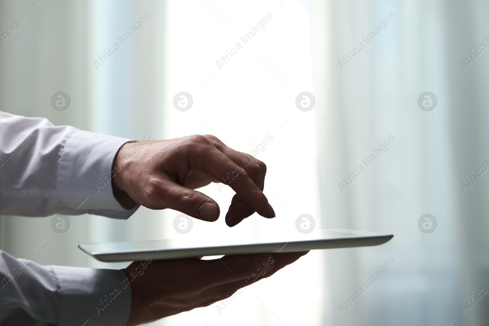 Photo of Closeup view of man using new tablet indoors