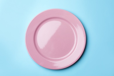 Photo of Stylish ceramic plate on color background, top view