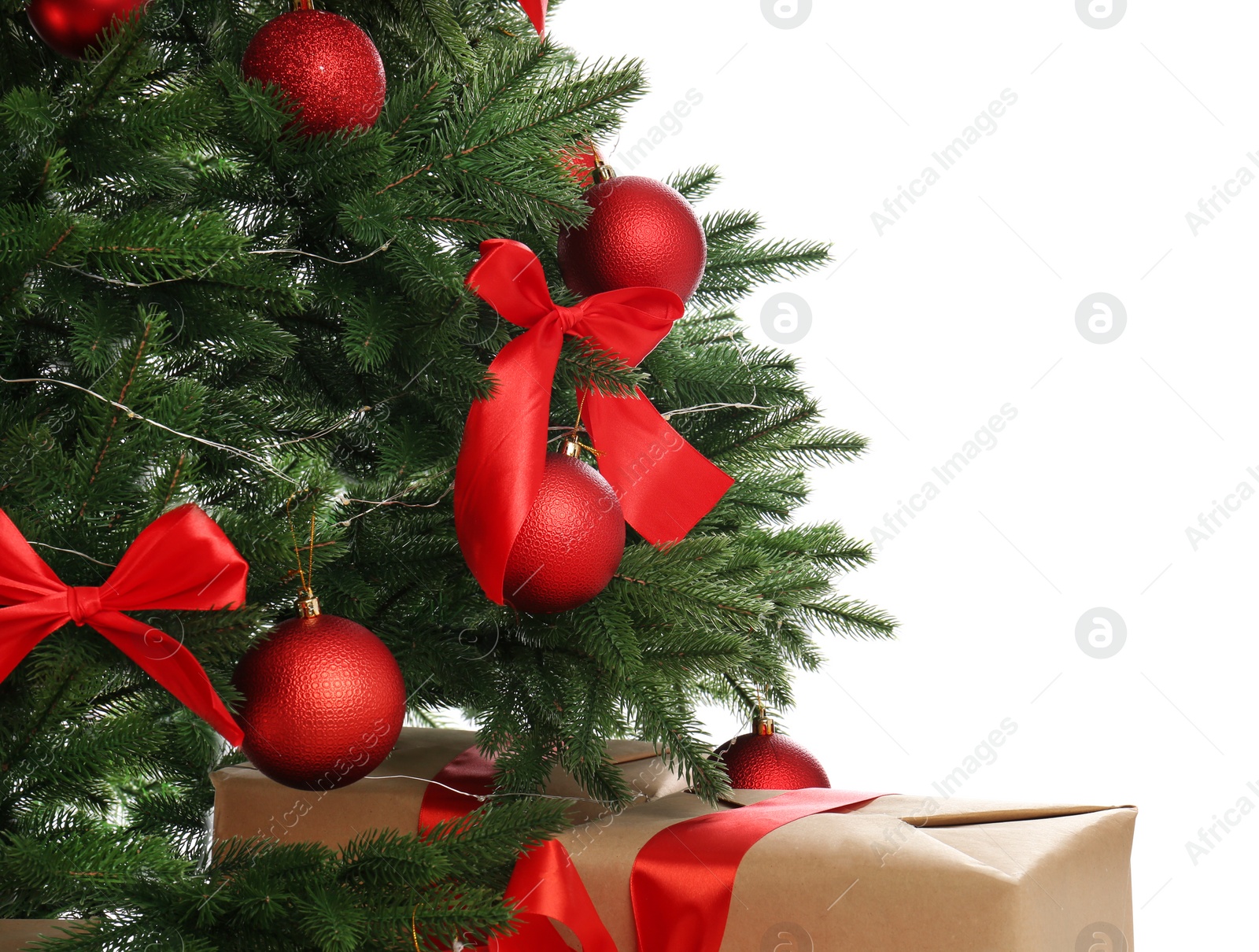 Image of Beautifully decorated Christmas tree and gifts on white background, closeup
