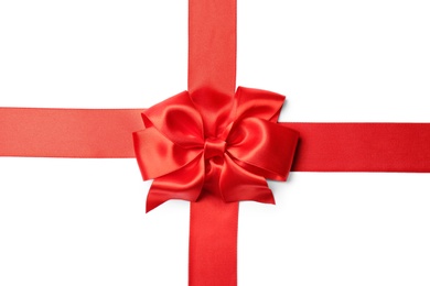 Photo of Red ribbon with bow on white background. Festive decoration