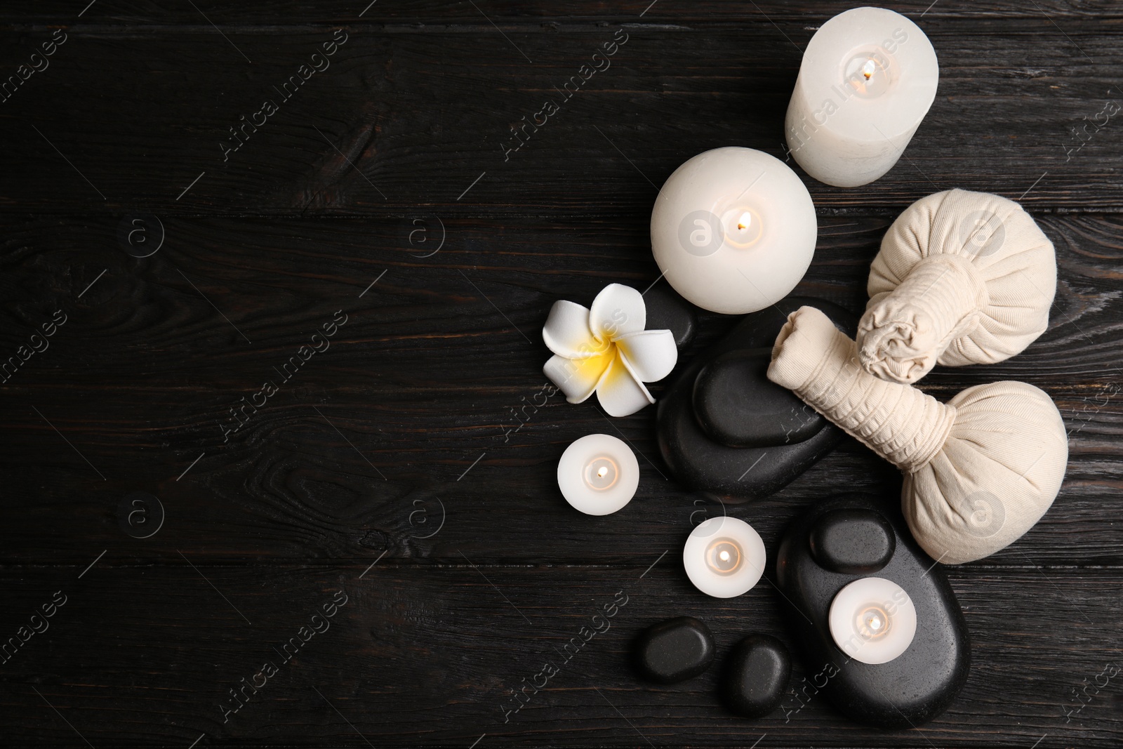 Photo of Spa composition with stones on wooden background, flat lay. Space for text