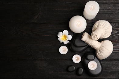 Spa composition with stones on wooden background, flat lay. Space for text