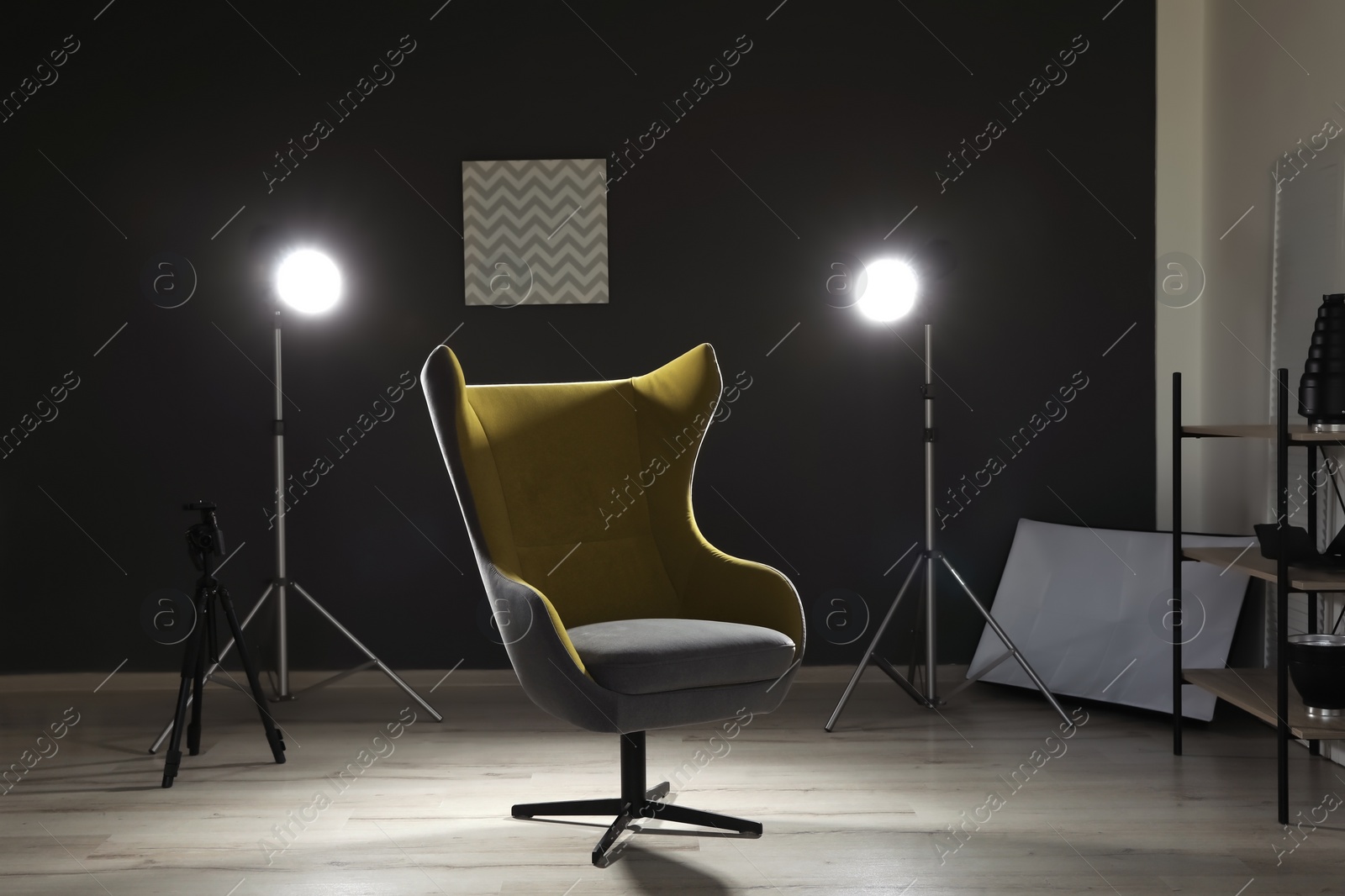 Photo of Interior of modern photo studio with armchair and professional equipment