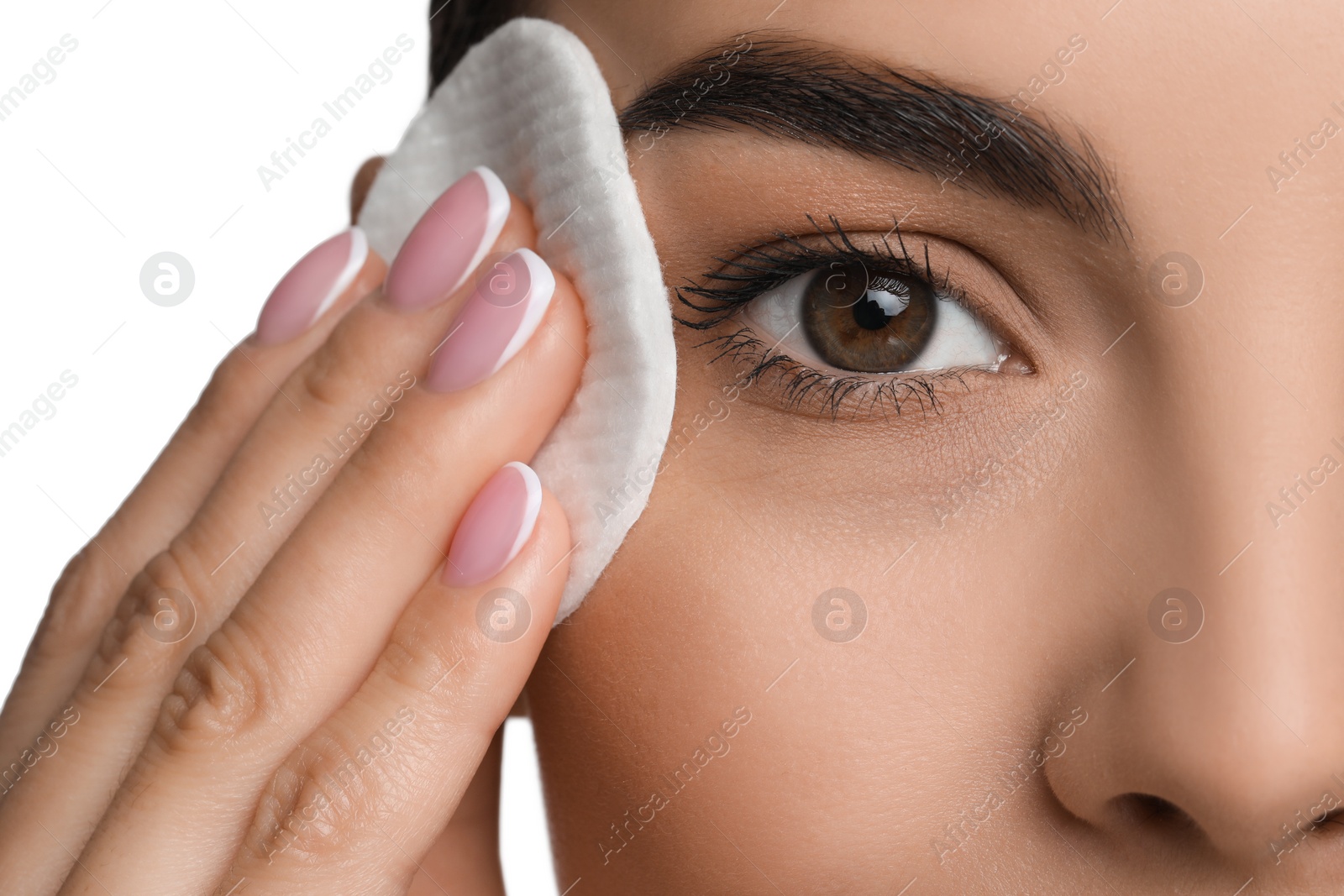 Photo of Beautiful woman removing makeup with cotton pad on white background, closeup