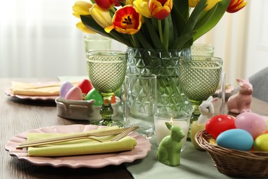 Easter celebration. Festive table setting with beautiful flowers and painted eggs