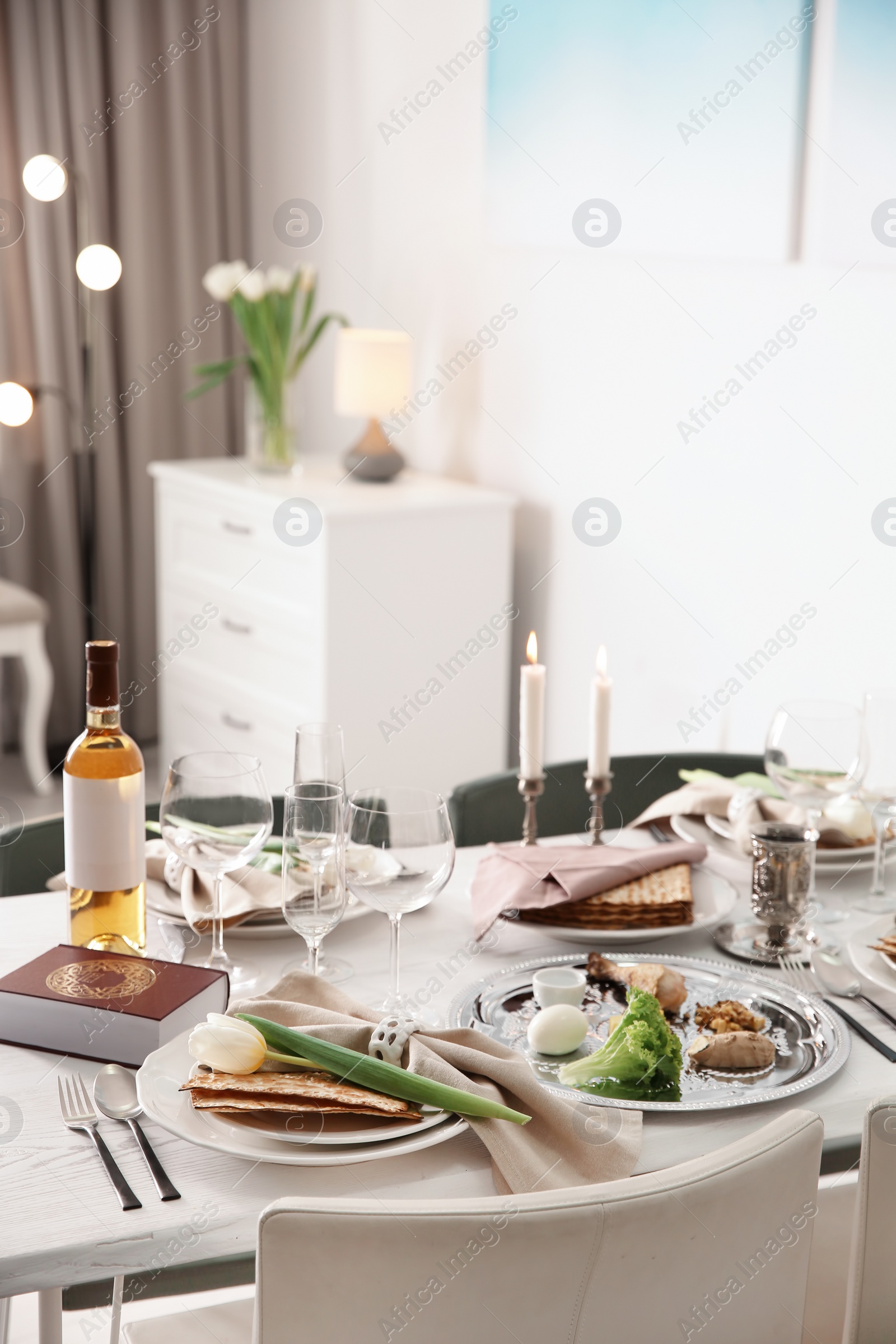 Photo of Festive Passover table setting with Torah at home. Pesach celebration