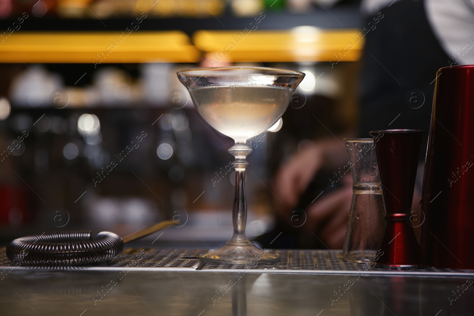 Photo of Glass of tasty cocktail on bar counter