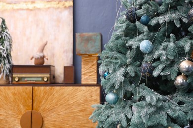 Room interior with Christmas tree and festive decor, space for text