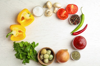 Photo of Frame of ingredients for cooking on white wooden table, flat lay. Space for text