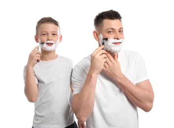 Photo of Dad shaving and son imitating him on white background