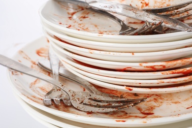 Pile of dirty dishes and cutlery, closeup