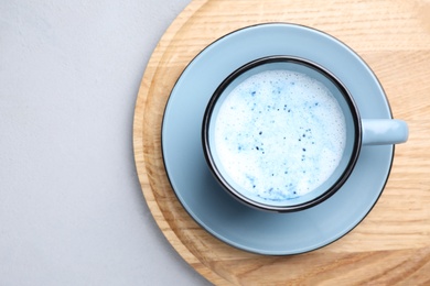 Image of Blue matcha latte in cup on grey table, top view