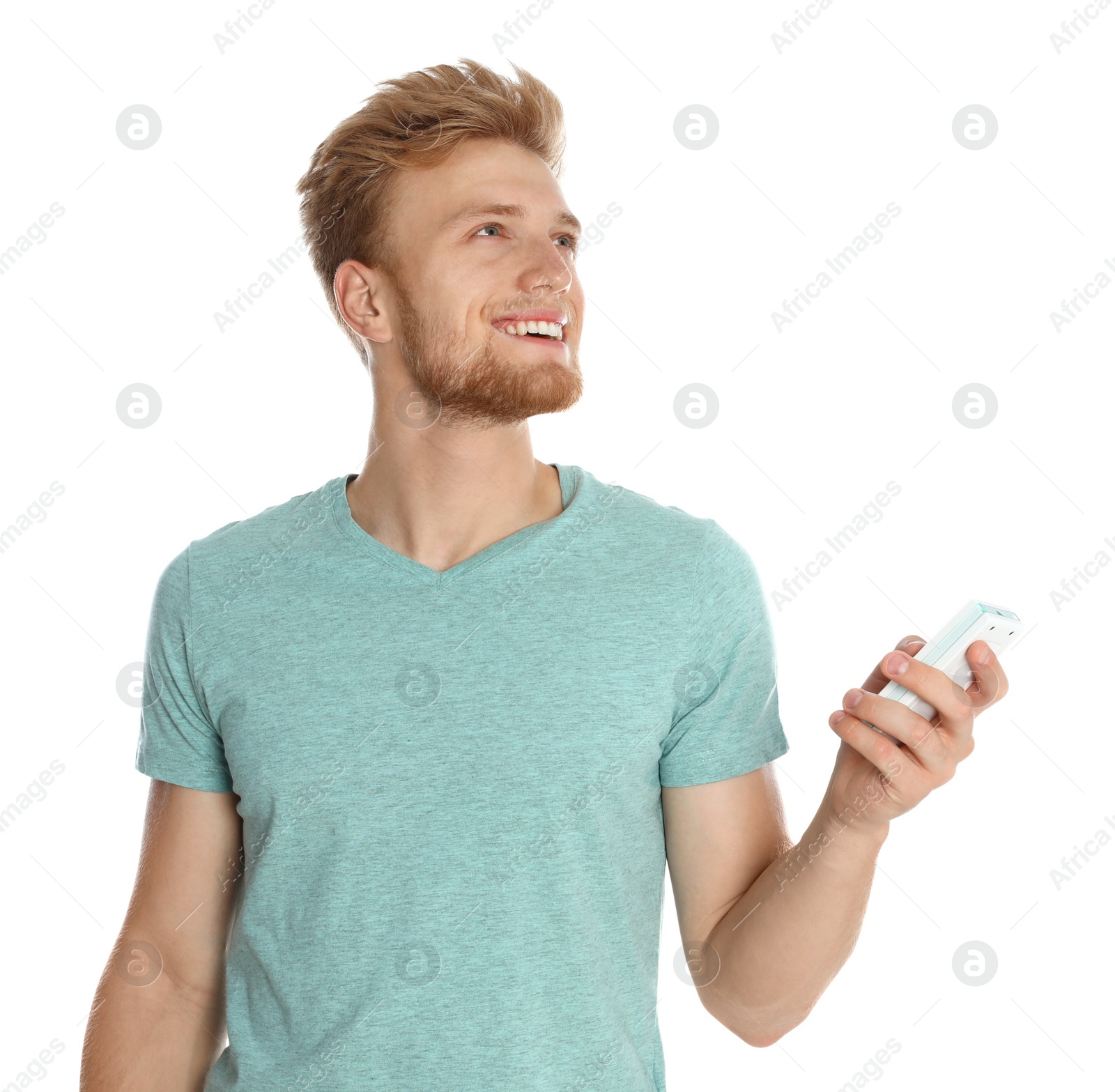 Photo of Young man with air conditioner remote on white background