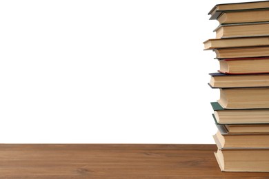 Stack of books on wooden table against white background. Library material