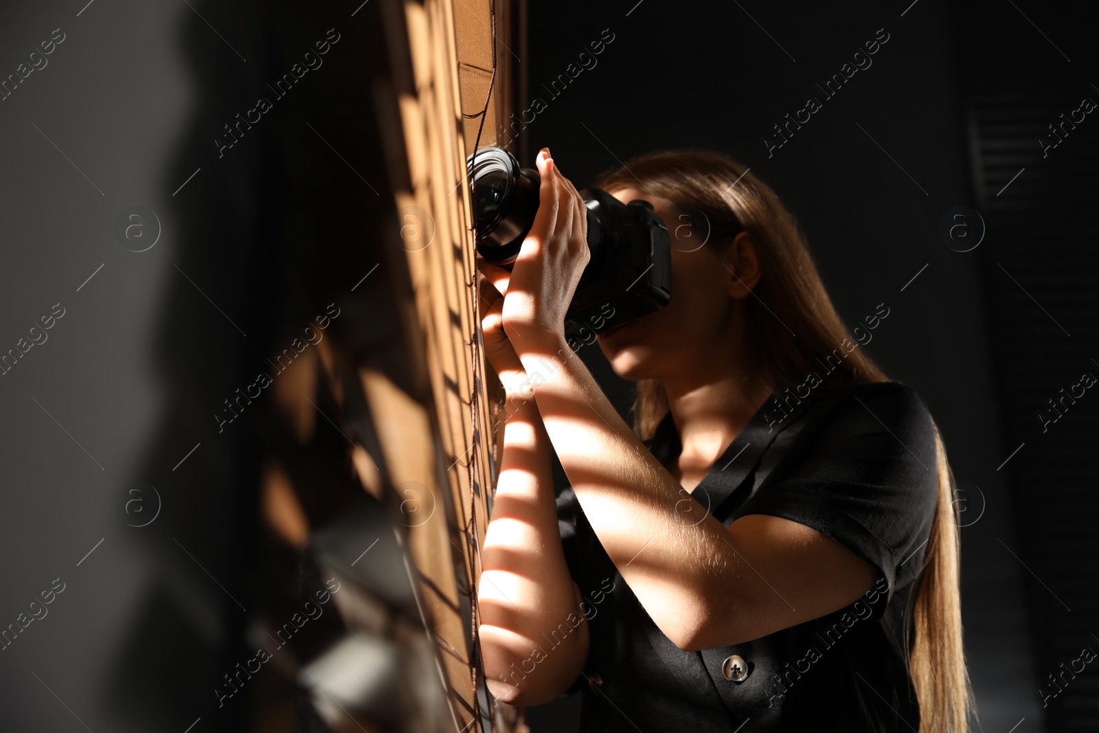 Photo of Private detective with camera spying near window indoors