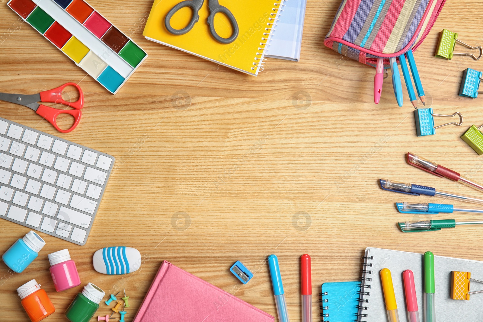 Photo of Different school stationery with space for design on wooden background, flat lay