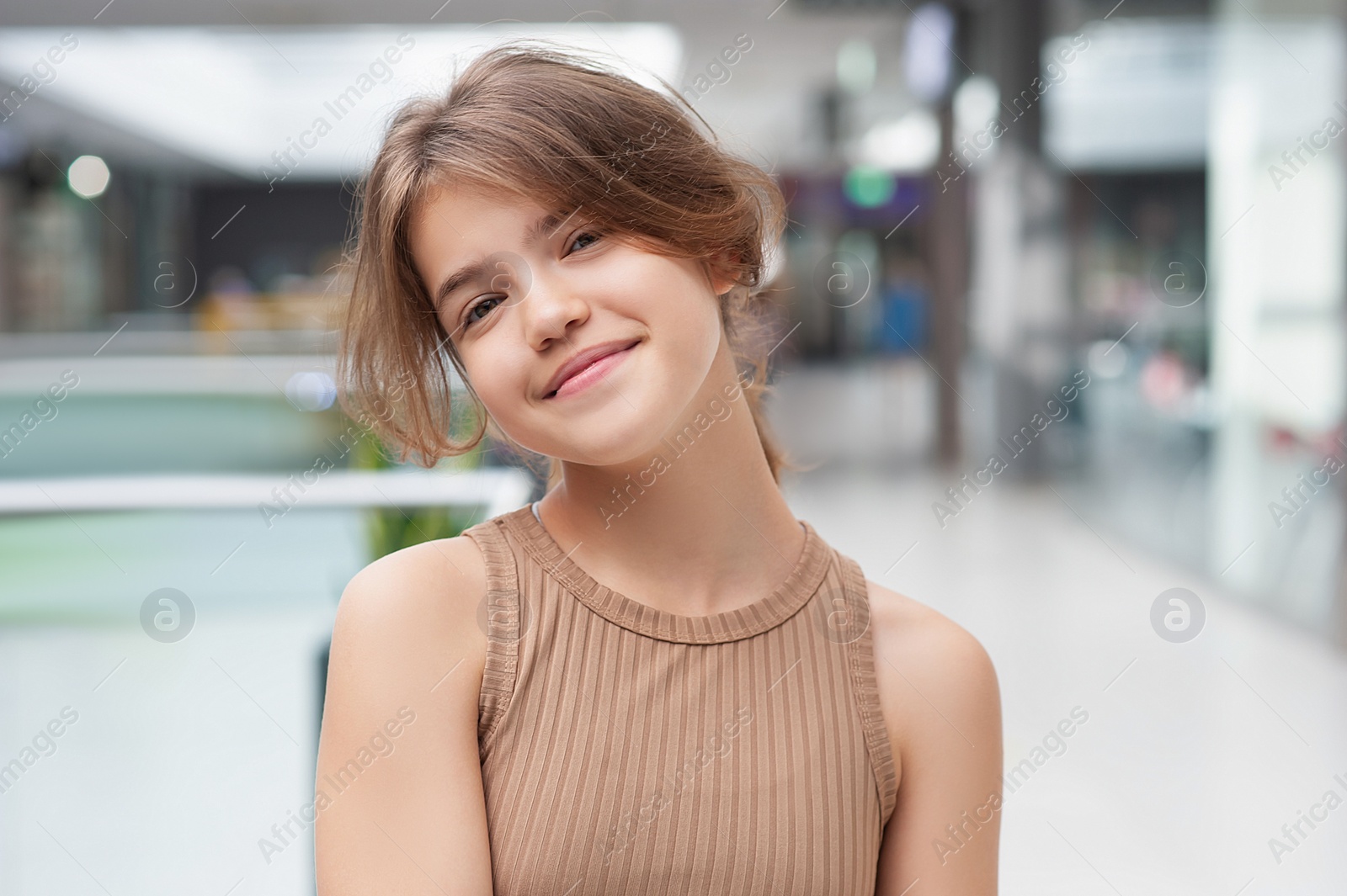 Photo of Portrait of beautiful teenage girl in shopping mall