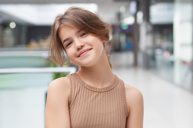 Portrait of beautiful teenage girl in shopping mall