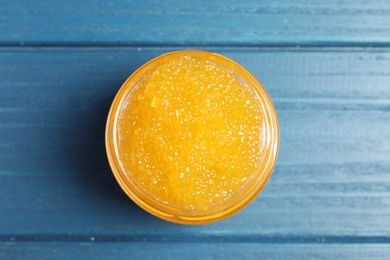 Photo of Fresh pike caviar in glass jar on blue wooden table, top view