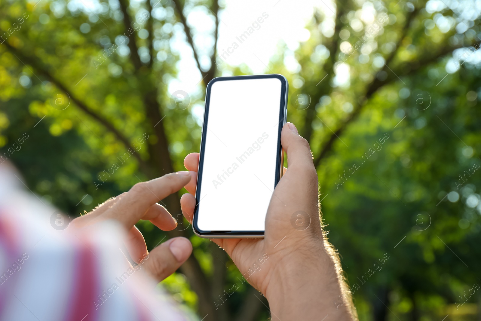 Photo of Man using modern mobile phone outdoors, closeup