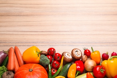 Photo of Flat lay composition with fresh vegetables on wooden table. Space for text