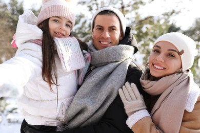 Happy family outdoors on winter day. Christmas vacation