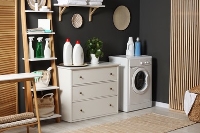 Photo of Laundry room interior with washing machine and furniture