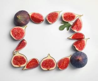 Photo of Flat lay composition with fresh ripe fig slices on white background. Space for text