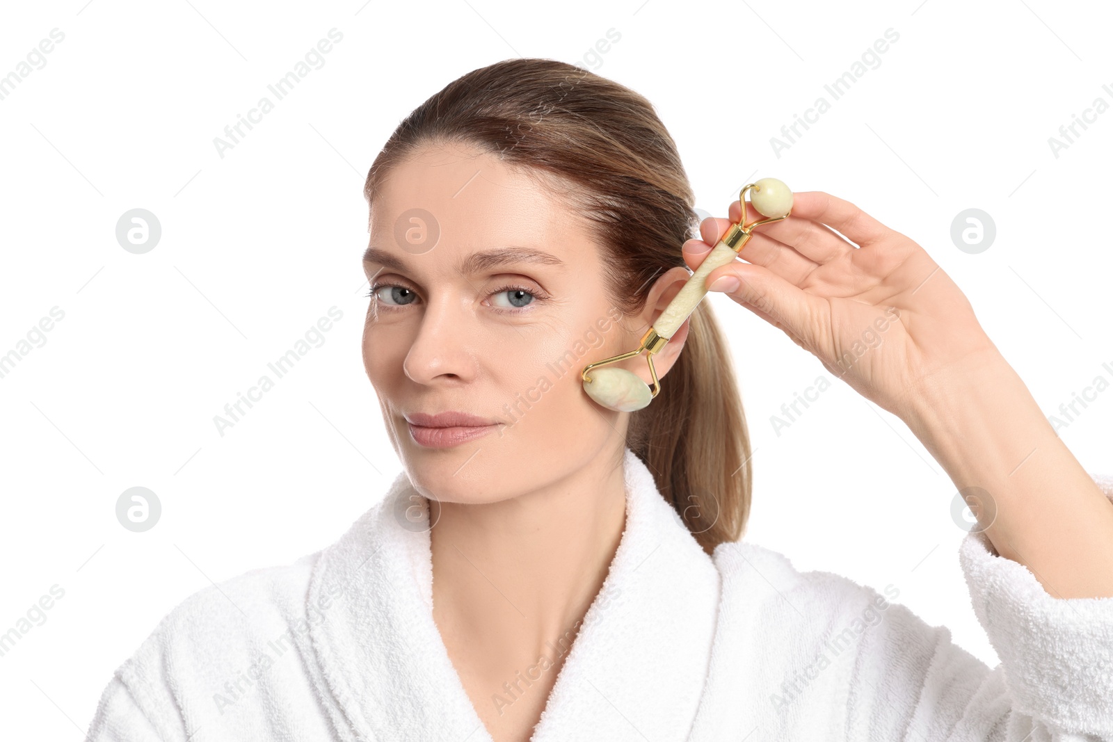Photo of Woman massaging her face with jade roller on white background