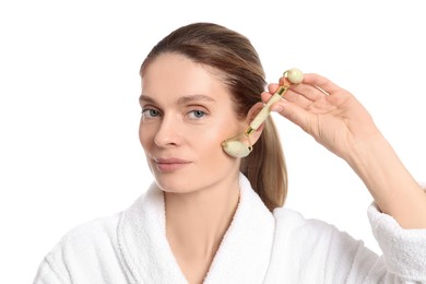 Woman massaging her face with jade roller on white background