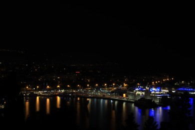 Photo of SPLIT, CROATIA - OCTOBER 08, 2023: Beautiful view of illuminated city with port and buildings at night