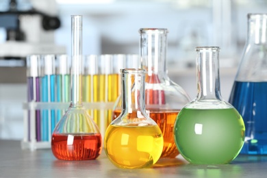 Glassware with colorful liquids on table in laboratory