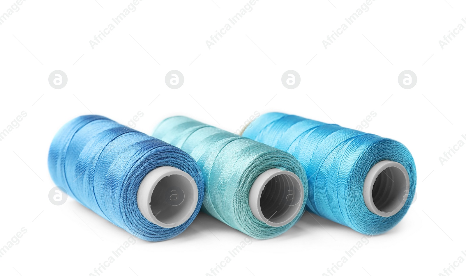 Photo of Color sewing threads on white background