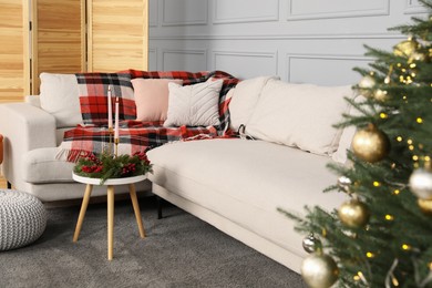 Photo of Sofa with pillows and Christmas decoration in living room