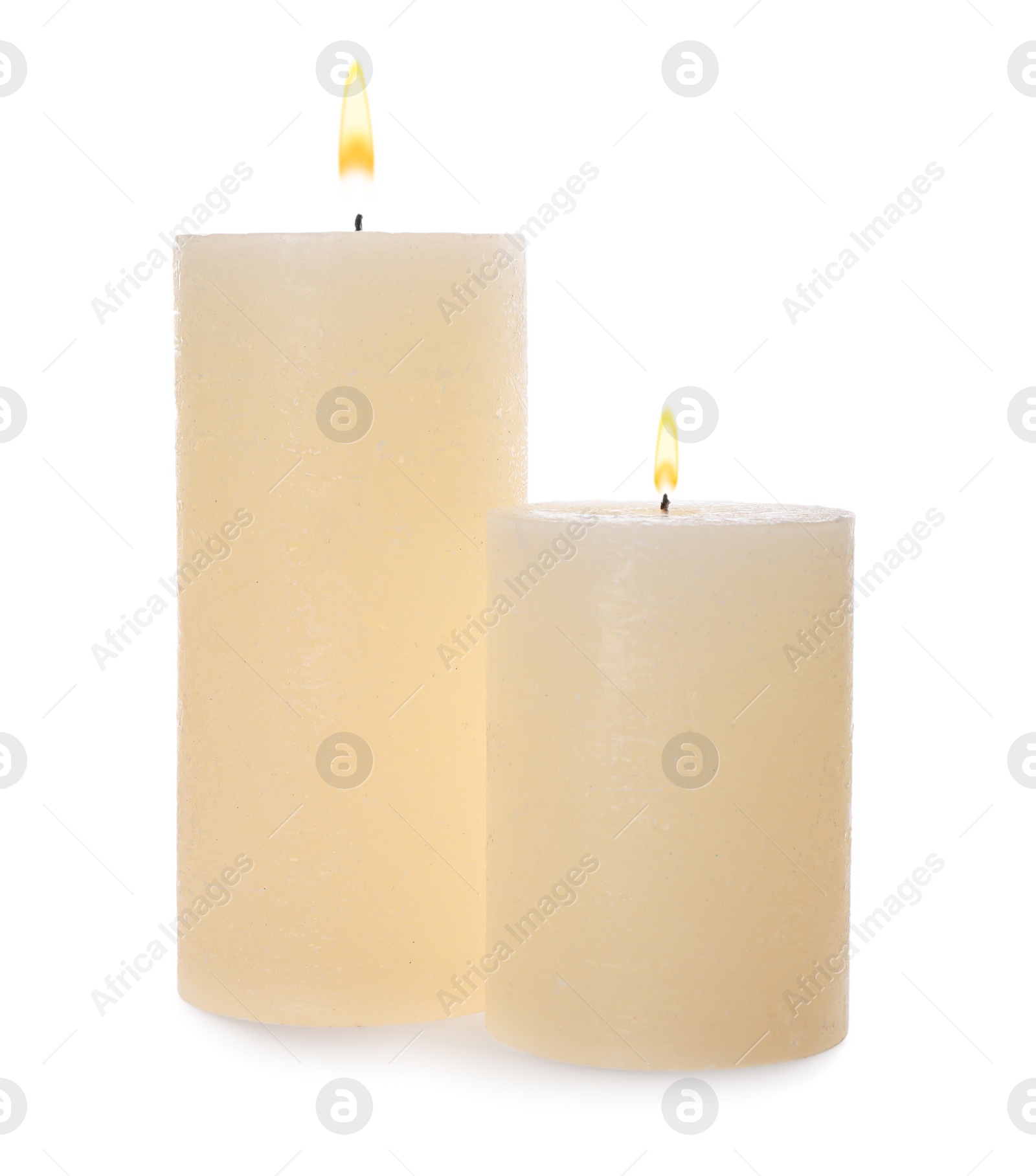 Photo of Two pillar wax candles isolated on white