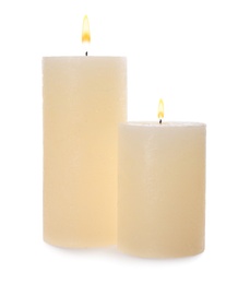 Photo of Two pillar wax candles isolated on white