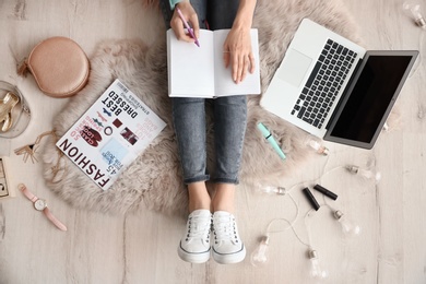 Photo of Female beauty blogger with notebook and laptop indoors, top view