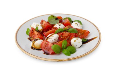 Tasty salad Caprese with mozarella balls, tomatoes, basil and sauce on white background